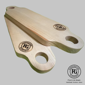 Form & Grain medium handcrafted spruce cheese board with selection of cheeses, bread, and walnuts, showing FG Handcrafted Elegance logo.”