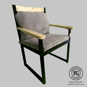 Mod-G Comforter dining chair with upholstered seat and back, steel frame with gripseal finish and solid timber armrests, shown in Hertex Balkan fabric